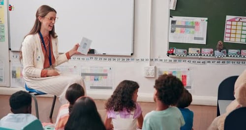 Teacher Giving Papers to Students in Classroom
