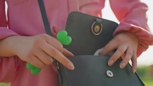 Woman Takes Silicone Toy From Handbag Outside Female Individual Removes Green Silicone Item From