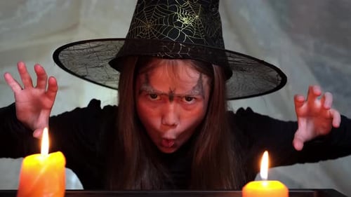 Girl Dressed as a Witch Smiles at the Camera