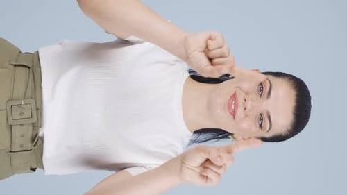 Woman in White Shirt Gestures with Hands