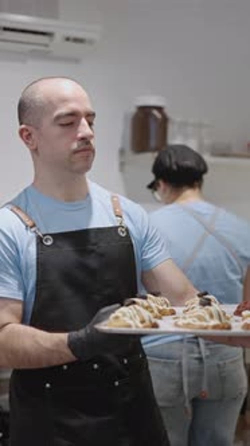 Baker Holding Tray of Pastries