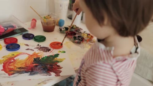 Child Painting with Bright Colors