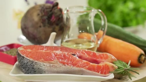 Fresh Salmon with Vegetables on a Wooden Surface