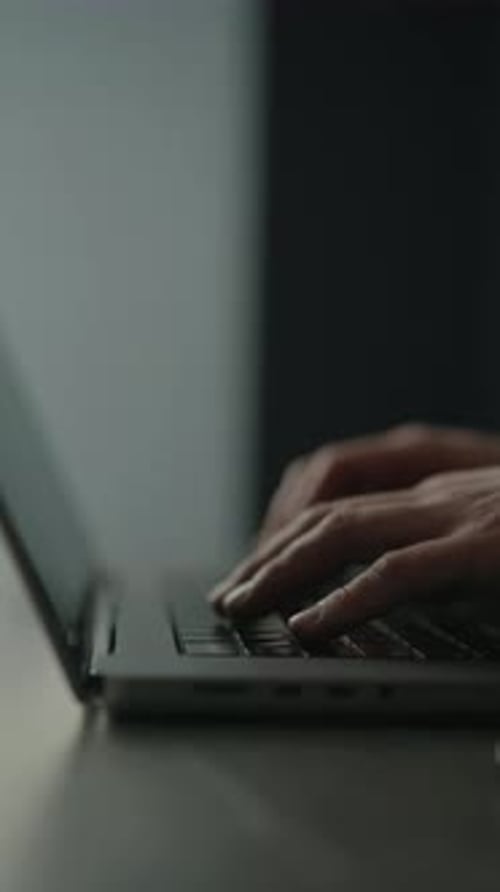 Hands Typing on a Laptop Keyboard Close Up