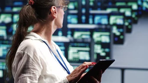 Woman Uses Tablet in Control Room