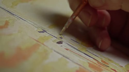 Female with brush drawing. Paint by numbers close up.