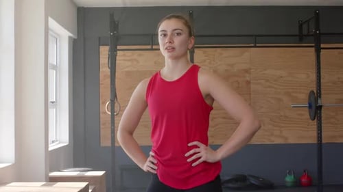 Portrait of tired unaltered caucasian woman taking a break from cross training at gym, slow motion