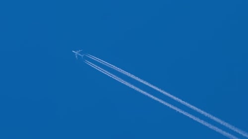 Highflying Jet Leaves Contrail in Clear Blue Sky
