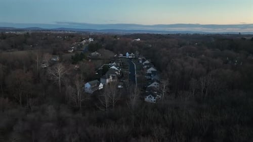 Luxury villas in american suburb neighborhood during early morning. Aerial approaching shot. Leafles