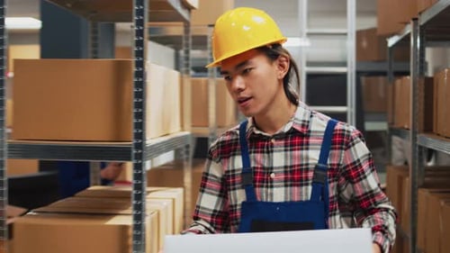 Warehouse Workers Examine Product For Shipment