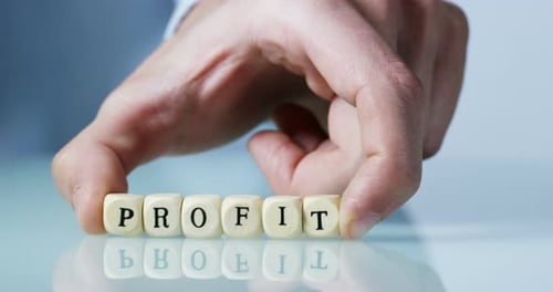 Slow motion macro of the word "Profit" of the wooden letter blocks . Concept of financial market a