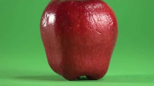 Red Apple Rotating on a Green Screen