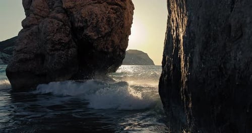 Background of the Nature Landscape of the Ocean with a Rocky Shore at Sunrise