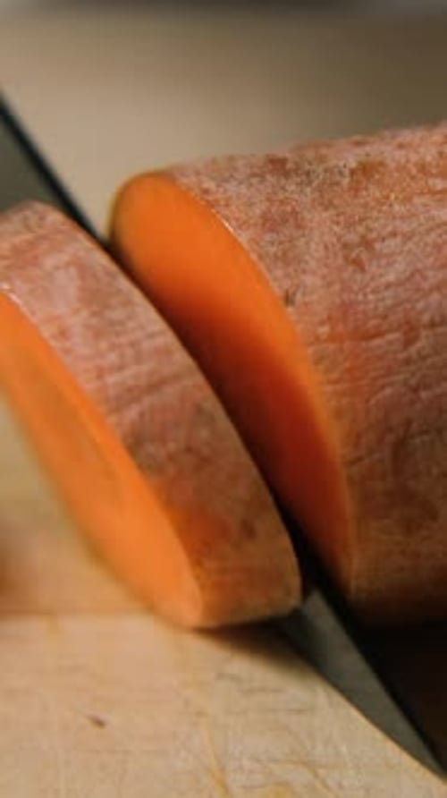 Macro Shot of Slicing Carrot on Wood Surface