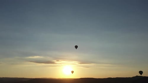 Hot Air Balloons Silhouetted at Sunset