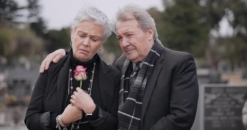 Funeral, graveyard and sad senior couple hug for comfort, empathy and support at memorial service