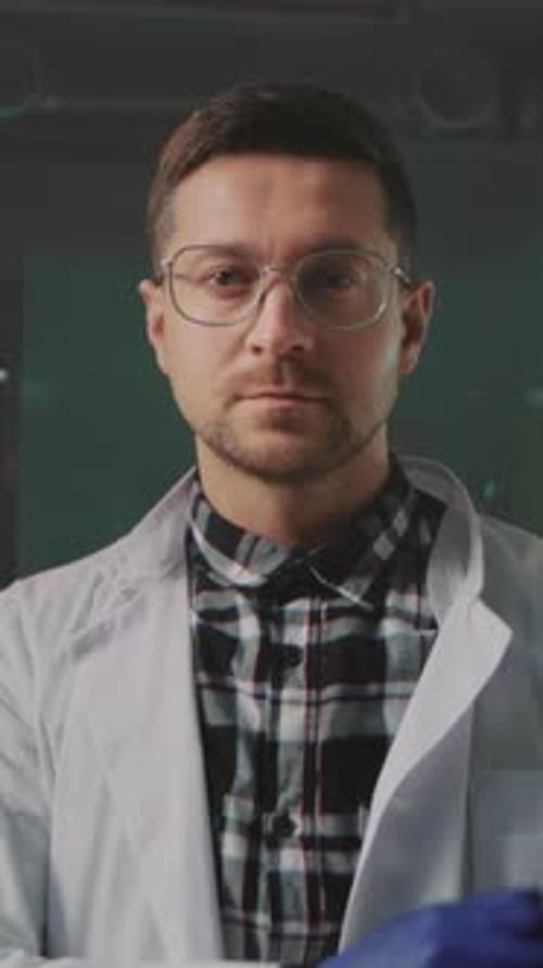 Scientist in Lab Coat Standing With Arms Crossed