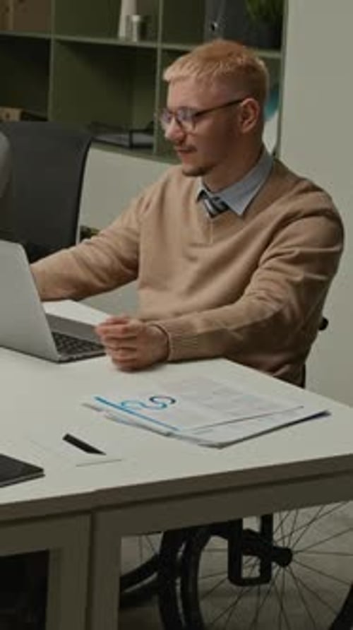 Adult in Wheelchair at Laptop in Office