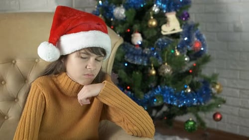 Teen Wearing Santa Hat Looking Annoyed