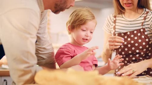 Caucasian attractive couple baking bakery with son in kitchen at home.