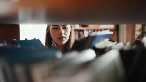 Front view of female student that searching books in library