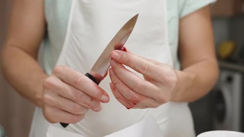 Woman Pitting Red Cherries with Sharp Knife