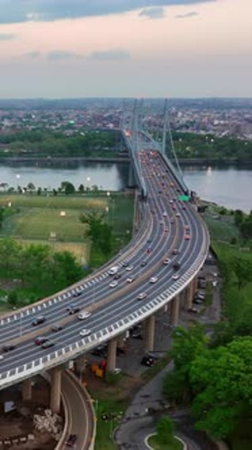 Two bridges nearby crossing New York river. Busy highway leading to the one of the bridges.