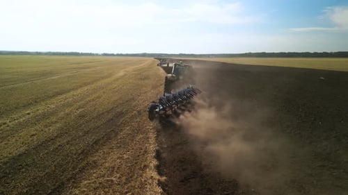 Tractors plowing the field in Ukraine
