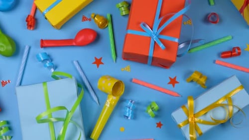 Festive Blue Background with Gift Boxes Candles Serpentine and Balls Top View