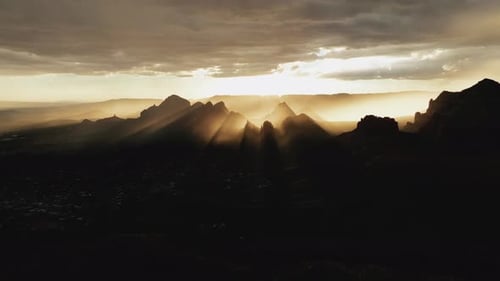 Sunburst Over Silhouetted Mountains In Sedona, Arizona During Sunrise. Aerial Shot