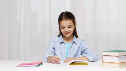 Happy School Girl with Books and Notepad at Home Book