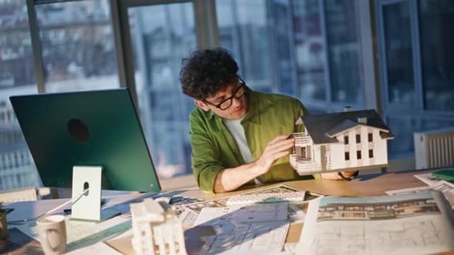 Architect Designs Building Model in Modern Office