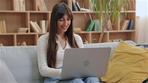 Young Woman Using Laptop Computer at Home