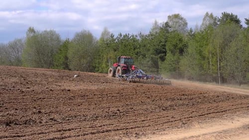 Tractor on the Farmer's Field Plows and Cultivates the Soil Agriculture Farming Business Harvest