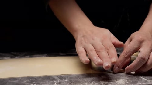 Hands Cutting Dough with Round Metal Cutter