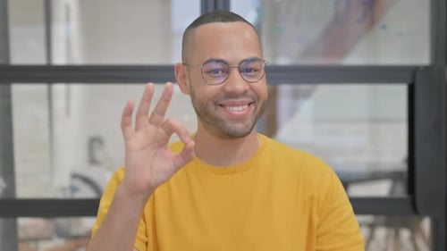 Young Man Giving Okay Hand Sign Close Up