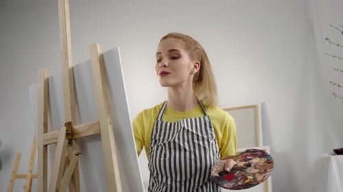 Young Adult Female Artist Drawing Picture By Oil Dyes in Art Studio Portrait Professional Painter or