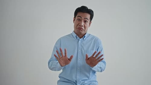 Young Man Doubting, Refusing and Forbidding on White Background