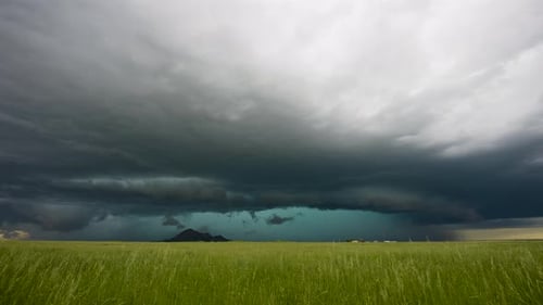 A Colorful Storm Drifts Over Green Summer Fields.