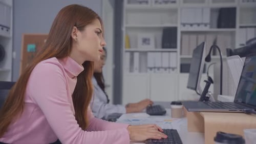 Frustrated Asian young businesswoman overwork late in office workplace.