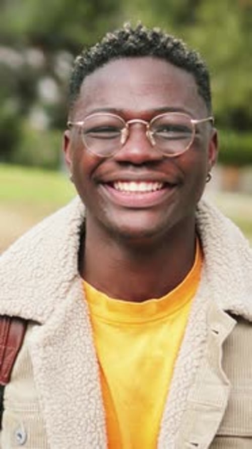 Vertical Close Up Portrait of African American Teenage Boy Looking at Camera Smiling and Laughing at