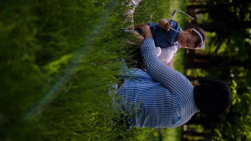 Mother and child together in the park outdoors, lying in the grass. Motherhood happiness concept. Da