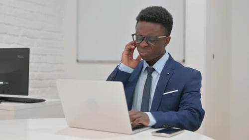 Young Adult Working on Laptop in Office
