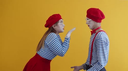 Two Mimes in Striped Shirts Gesturing to Each Other
