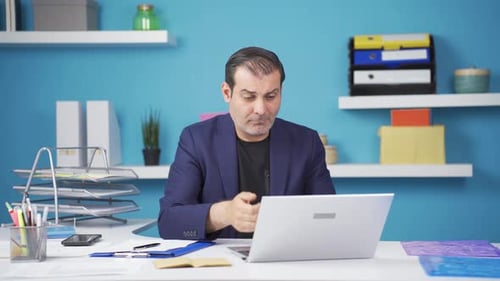 Upset Man Working at Office Desk