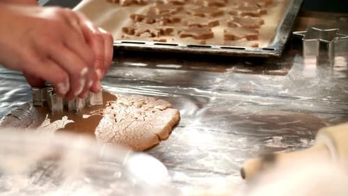 Hands Cutting Star Cookies in Home Kitchen