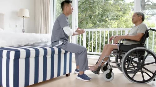 Young Adult Medical Professional Talking With Senior Patient