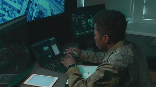 Male Military Officer Tracking Object and Making Notes