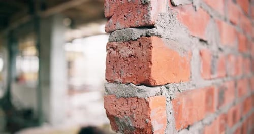 Empty, site and building with brick wall for construction, foundation and cement for masonry