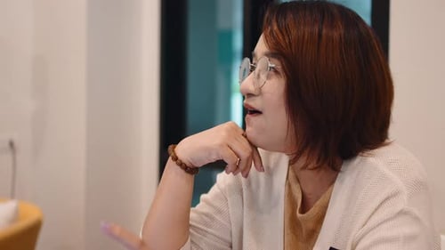 Asian Businesswoman Talking and Working in Office